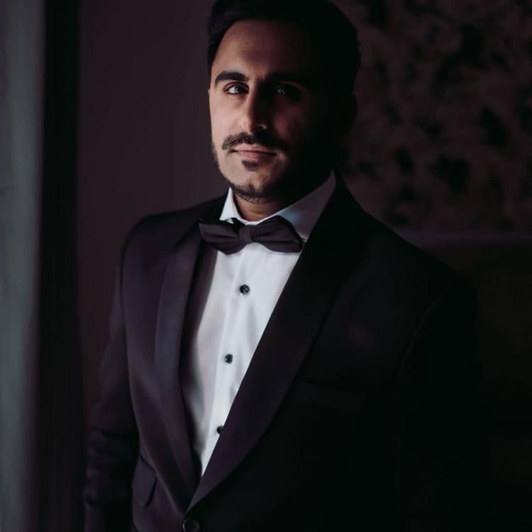 A client in a midnight tuxedo with a bow tie
