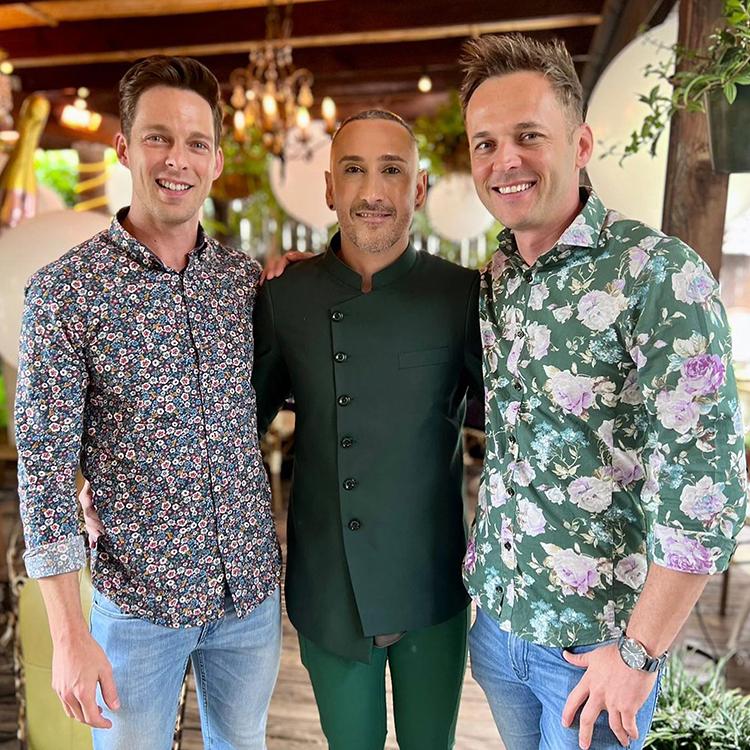 A client in a custom dark green mandarin collar jacket with friends